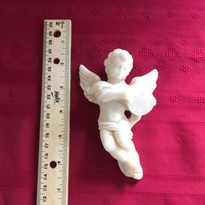 Cast marble cherub wall hanging